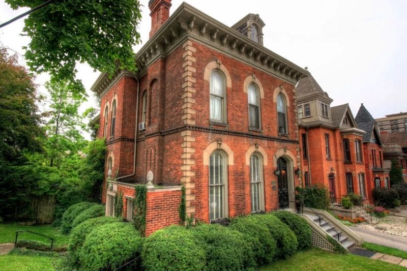 The Balfour House at 250 James Street South, an 1880 Victorian masterpiece in Hamilton, Ontario, showcasing Second Empire architectural splendor with arched windows, a mansard roof, and ornate brickwork.
